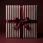 Burgundy and white striped gift box with a matching satin ribbon and bow, perfect for Christmas or birthdays.