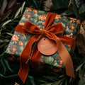 Luxury cactus floral wrapping paper with a burnt orange velvet bow by Wrapped Studios.