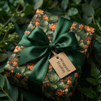 Botanical cactus wrapping paper with a luxury green satin bow and Wrapped Studios gift tag.
