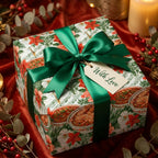 Luxury Christmas gift wrap with floral design, green satin ribbon, and tag by Wrapped Studios.