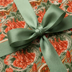 Cajun crawfish boil wrapping paper with a sage green satin bow, luxury gift wrap by Wrapped Studios.