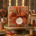 Cajun crawfish food wrapping paper with an orange burlap bow on a rustic gift box, by Wrapped Studios.