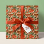 Cajun crawfish boil wrapping paper with a rust orange ribbon on a gift box by Wrapped Studios.