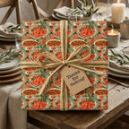 Green seafood wrapping paper with a hostess gift tag and raffia bow on a rustic table by Wrapped Studios.