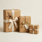 Solid tan gift wrapping paper with satin ribbons, gold cord, and decorative botanical accents.