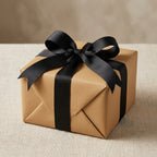 Kraft wrapping paper gift with elegant black ribbon bow, perfect for birthday or holiday presents.