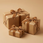 Three tan gift boxes wrapped in plain wrapping paper and velvet ribbon, ideal for birthdays or wedding presents.