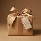 Elegant gold wrapping paper on a square gift box, tied with satin ribbon and a gift tag.