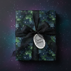 Galaxy gift wrap with black ribbon, "Cosmic Wishes" tag, on a starry background.