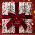 Luxury Christmas gift wrap with vintage candy cane pattern and red velvet bow by Wrapped Studios.