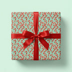 Mint green candy cane Christmas wrapping paper with a red ribbon by Wrapped Studios.