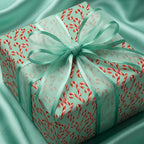 Mint green candy cane Christmas gift wrap with a matching sheer bow by Wrapped Studios.