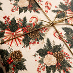 Vintage Christmas wrapping paper with floral pinecone pattern and gold string bow by Wrapped Studios.