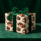 Vintage Christmas wrapping paper with a botanical pinecone pattern and green velvet bow by Wrapped Studios.