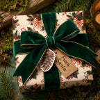 Vintage Christmas wrapping paper with a green velvet bow and 'From Santa' tag by Wrapped Studios.