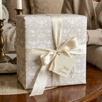 Elegant dove baptism wrapping paper with cream satin bow and gift tag from Wrapped Studios.