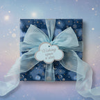 Navy gift box wrapped in celestial star wrapping paper with light blue ribbon and "Wishing upon a star" tag.