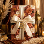Luxury terracotta boho floral wrapping paper with a cream satin bow on a gift box, by Wrapped Studios.