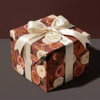 Elegant vintage floral wrapping paper with cream satin bow on a gift box, from Wrapped Studios.