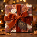 Luxury vintage floral wrapping paper with a terracotta velvet bow on a cozy fall gift box by Wrapped Studios.