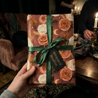 Luxury vintage floral wrapping paper with a green ribbon and Wrapped Studios tag.