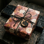 Vintage floral Christmas wrapping paper with a wooden Noel tag and twine by Wrapped Studios.