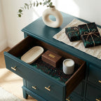 Dark green starry Christmas wrapping paper on gifts and used as a drawer liner by Wrapped Studios.