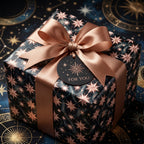 Luxury celestial holiday wrapping paper in navy and rose gold with a satin bow by Wrapped Studios.
