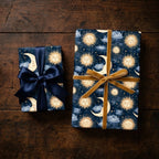Celestial wrapping paper with sun and moon print, tied with velvet and satin ribbons by Wrapped Studios.