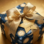Luxury celestial wrapping paper with gold suns and moons, a gold bow, and star gift tag by Wrapped Studios.