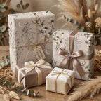 Celestial floral wrapping paper on luxury cream gift boxes with satin ribbon, by Wrapped Studios.