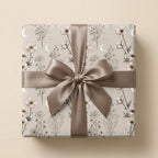 Elegant celestial floral wrapping paper by Wrapped Studios, featuring crescent moons and a taupe satin bow.