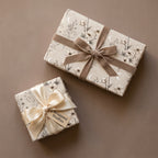 Luxury celestial floral wrapping paper with velvet ribbons on gift boxes, by Wrapped Studios.