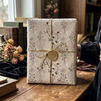 Vintage celestial wrapping paper with botanical wildflowers and crescent moons by Wrapped Studios.