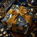 Celestial wrapping paper with gold velvet bow on a mystical sun and moon gift box, Wrapped Studios.