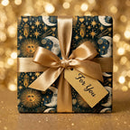 Celestial wrapping paper with gold sun and moon pattern and satin bow by Wrapped Studios.