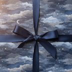 Night sky wrapping paper with white stars and a navy satin ribbon, perfect for birthday gift wrap.