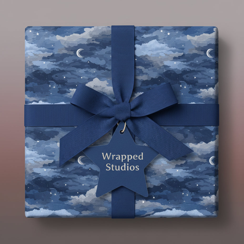 Square gift wrapped in celestial wrapping paper with navy ribbon and star tag.