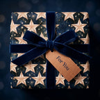 Luxury celestial star wrapping paper with a navy velvet bow on a gift box by Wrapped Studios.