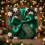 Luxury Christmas wrapping paper with vintage star pattern and green satin bow, by Wrapped Studios.