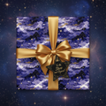 Square gift wrapped in luxury galaxy wrapping paper with gold ribbon and star tag.
