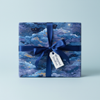 Square gift wrapped in elegant blue celestial wrapping paper with a navy bow.