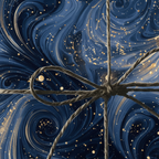 Elegant gift wrapped in swirl patterned blue wrapping paper with gold sparkles and twine bow.