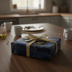 Navy blue and gold luxury gift wrap with ribbon on a present, modern design, kitchen setting.