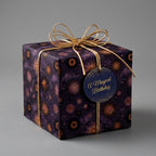 Celestial purple birthday wrapping paper with gold starbursts and a gold bow by Wrapped Studios.