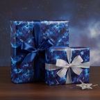 Navy blue galaxy wrapping paper with satin ribbon and bows on two square gift boxes.