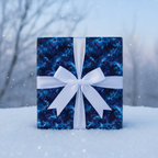 Navy blue Christmas gift wrap with a white satin bow sits in the snow.