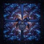 Elegant square gift wrapped in galaxy themed wrapping paper with a navy ribbon and bow.