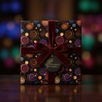 Elegant gift wrapped in modern spiral print paper, tied with a burgundy velvet ribbon, perfect for holiday or birthday.