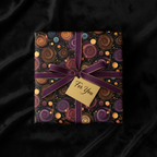 Elegant gift wrapped in dark floral wrapping paper with a purple ribbon and "For You" tag.